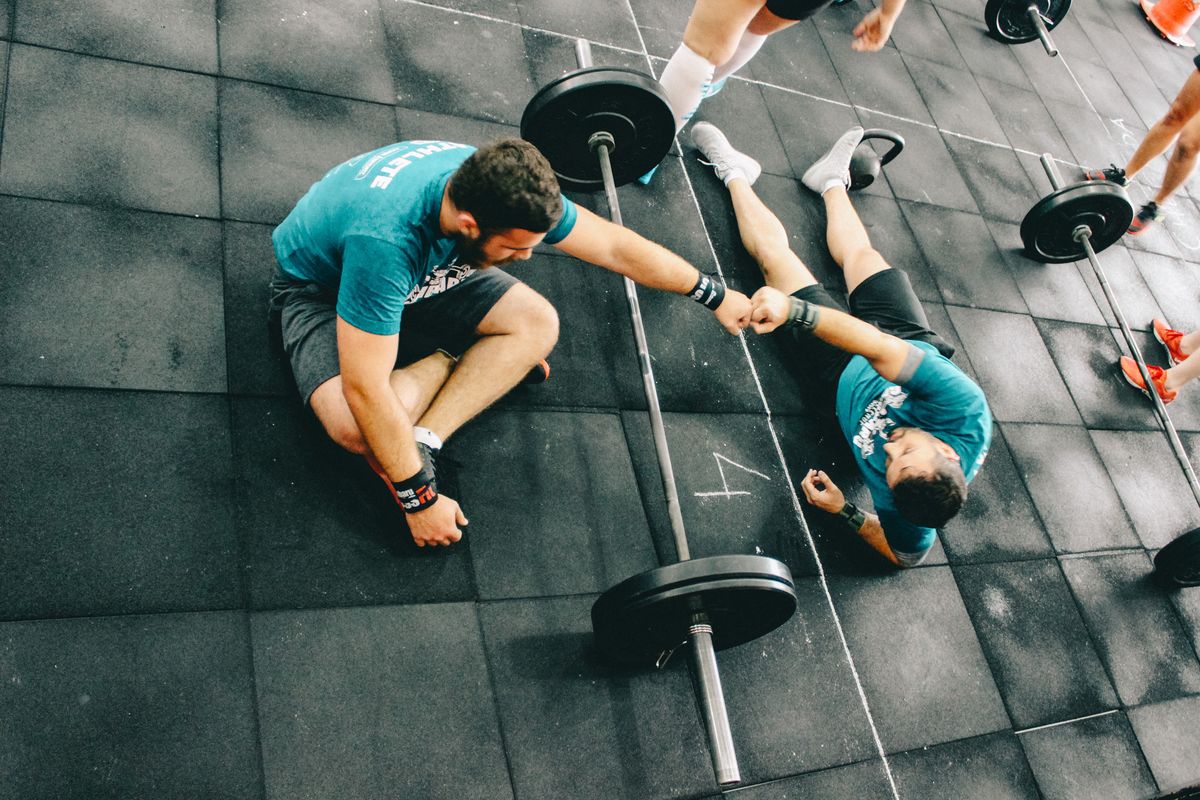 Personal trainer and client working out in a gym