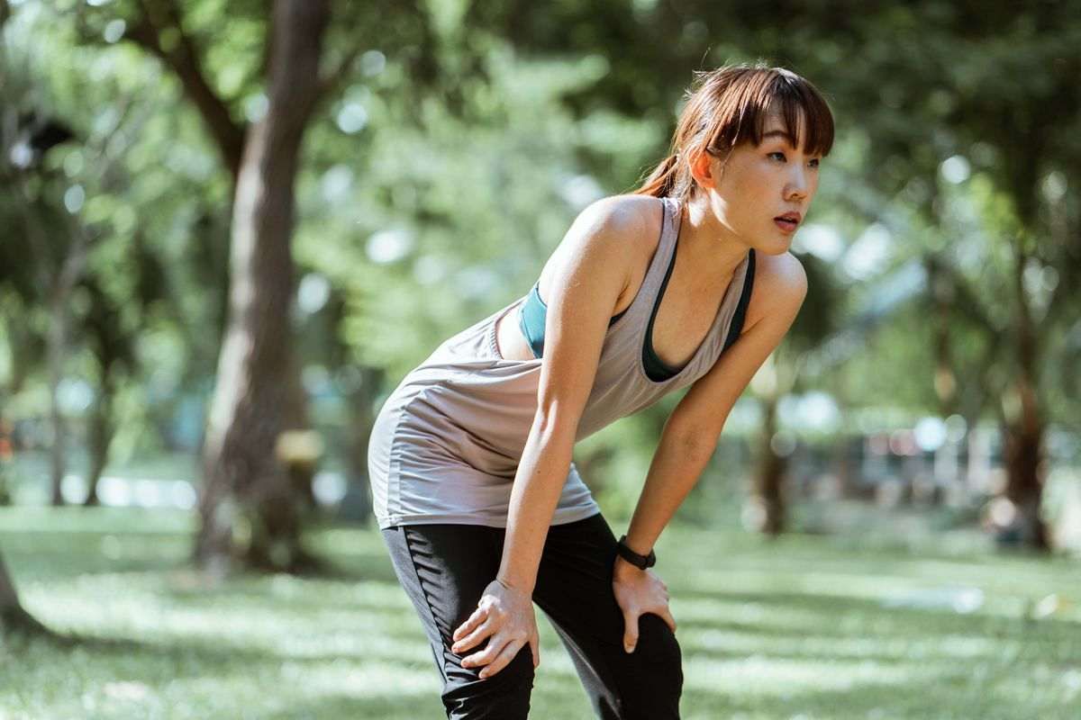 A woman stretching to promote post-exercise recovery.