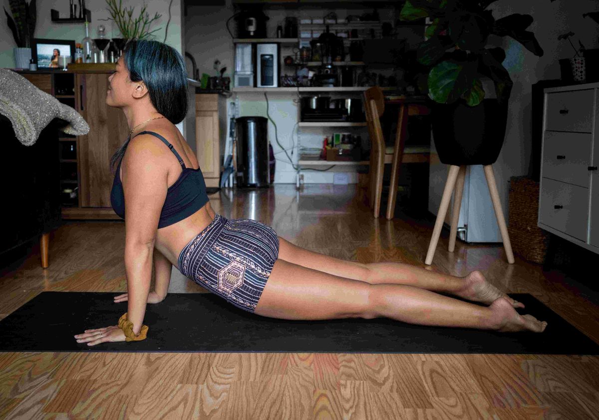 A woman using an at-home gym. 