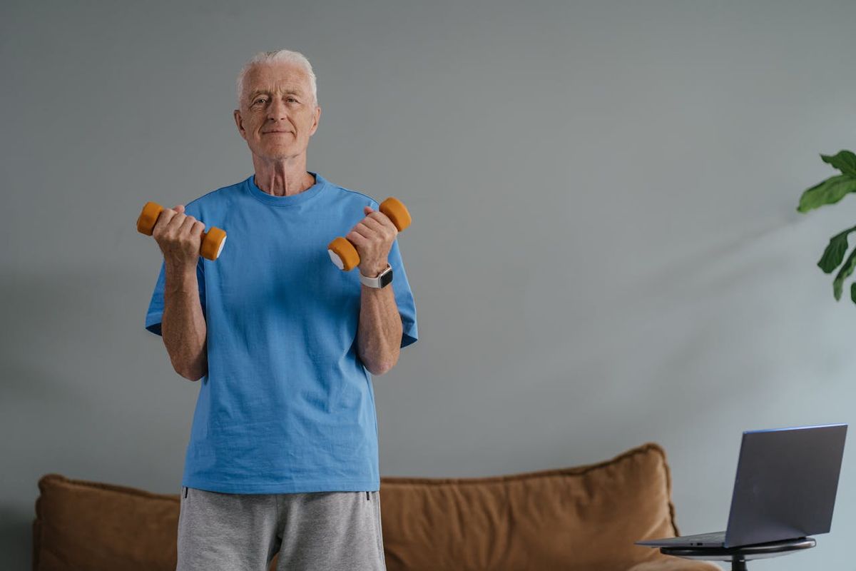 An older gentleman lifting weights