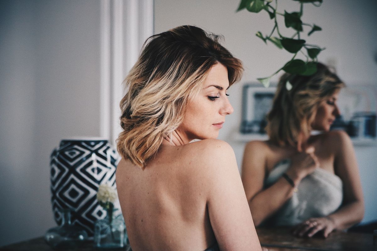 A woman fixing her rounded shoulders. 