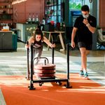 A personal trainer and a client in a gym