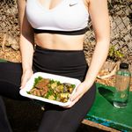 A woman holding a plate of healthy food