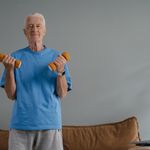 An older gentleman lifting weights