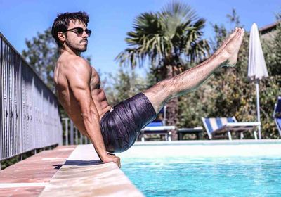 A personal trainer completing calisthenics exercises for beginners.