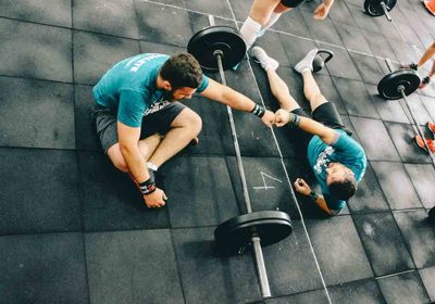 Two people discussing why to get a personal trainer. 