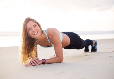 Personal trainer working out on the beach