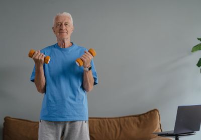 An older gentleman lifting weights