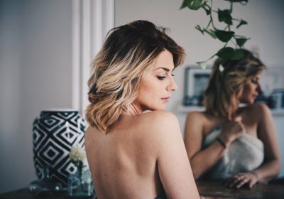 A woman fixing her rounded shoulders. 