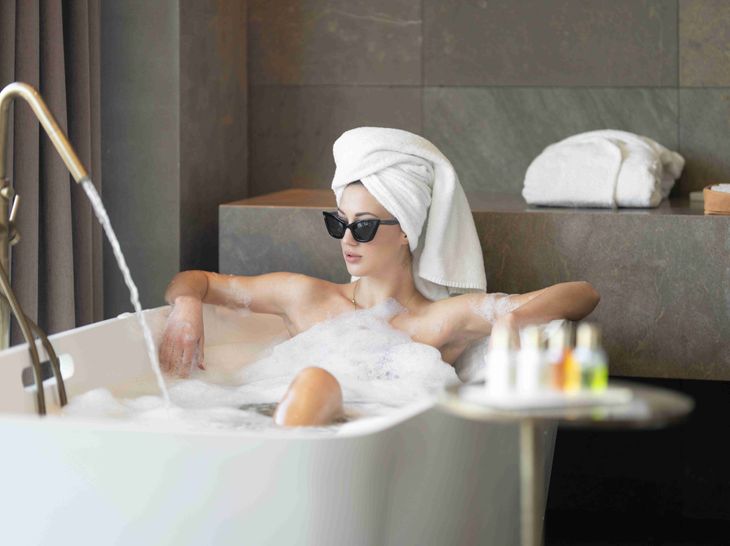 A woman in a bath practising self-care.