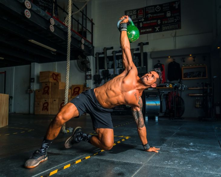 A man exercising with a kettlebell. 