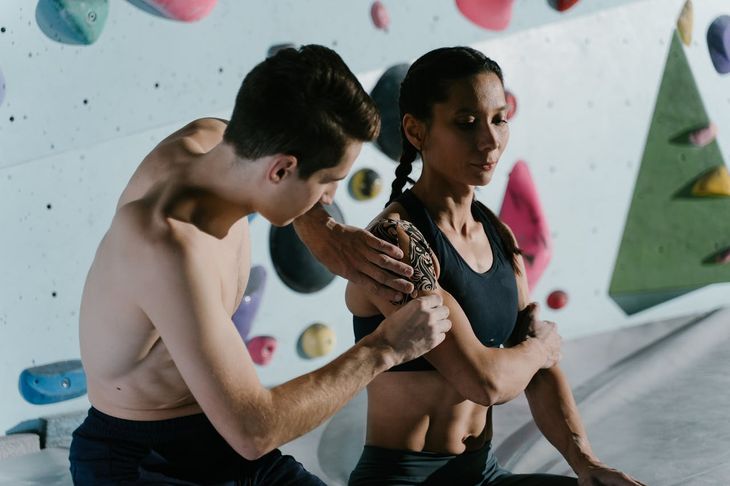 A personal trainer giving a woman first aid