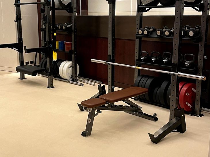 Bench on gym flooring for a home gym. 