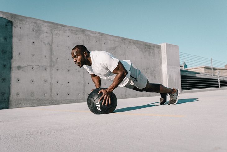 Man doing push ups as part of a weight loss circuit workout.