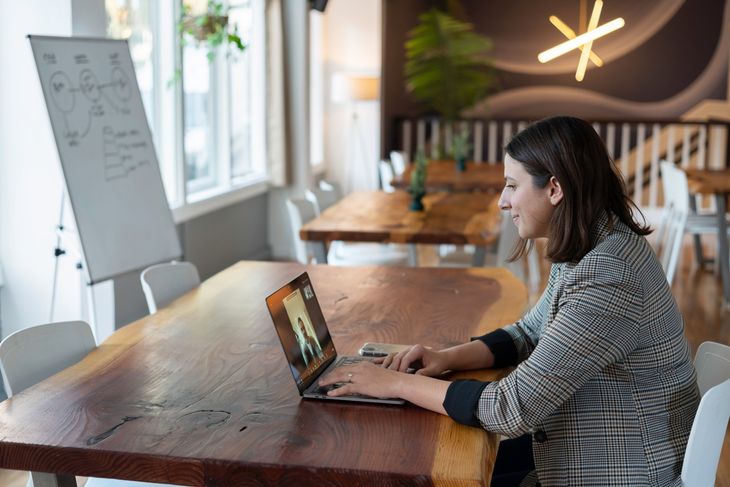 An online PT working on her laptop