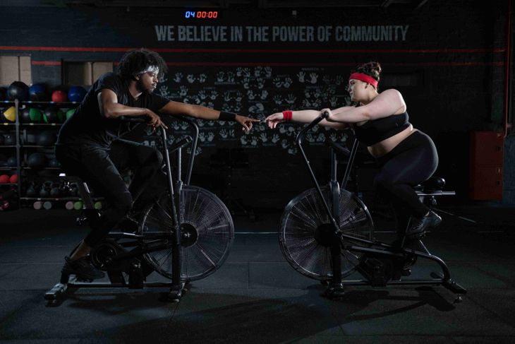 People riding folding exercise bikes.