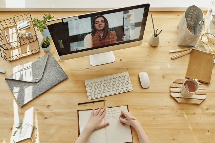 An insured personal trainer and their client working online.