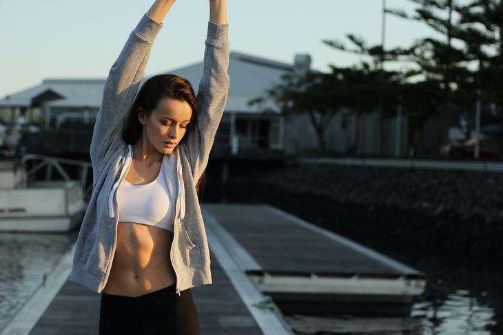 A woman enjoying the benefits of warming up before exercise.