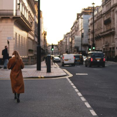 A woman crossing a street in London